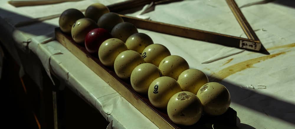Antique pool balls on a vintage table