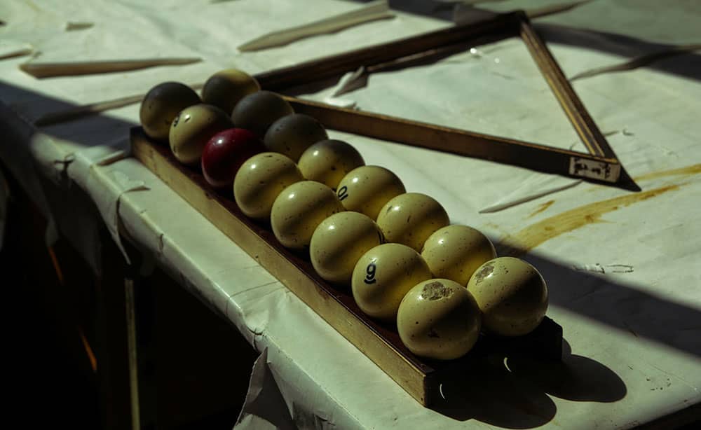vintage pool balls on antique table
