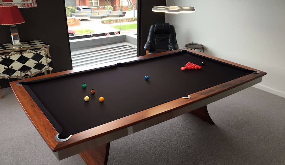 A black wood pool table made by the team at Quedos.