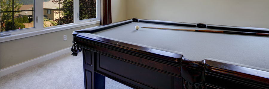 A classic old pool table displayed in a games room in all it's glory.