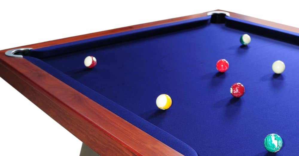 A pool table with quality cushions and rails and blue felt.