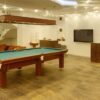 A billiards table is a timeless addition to any game room that is sure to provide hours of entertainment and fun.